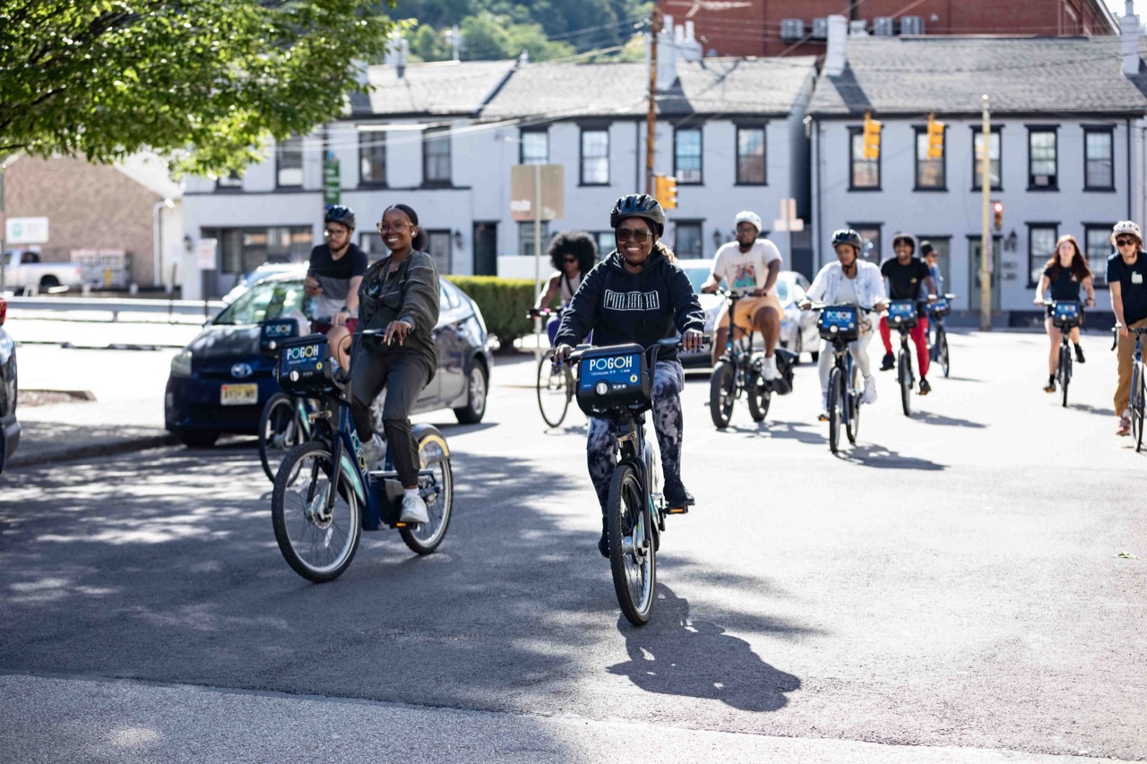Neighborhood group ride on POGOH bikes through Pittsburgh streets